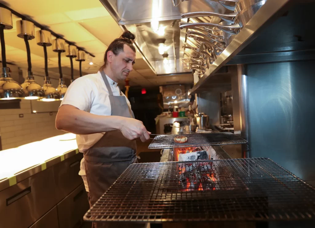 Chef Anthony Gonçalves preparing a dish in the kitchen of Kanopi Restaurant in White Plains on Friday, January 17, 2020.