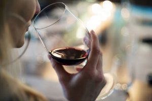 Woman tasting red wine