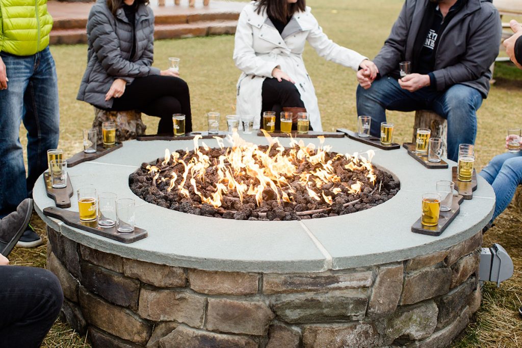 People gathered around an Angry Orchard campfire in Walden.