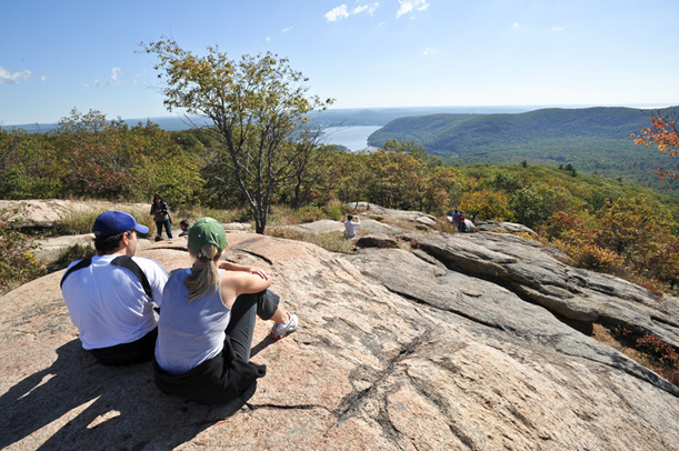 Hikers sitting on the ground at Bear Mountain Park