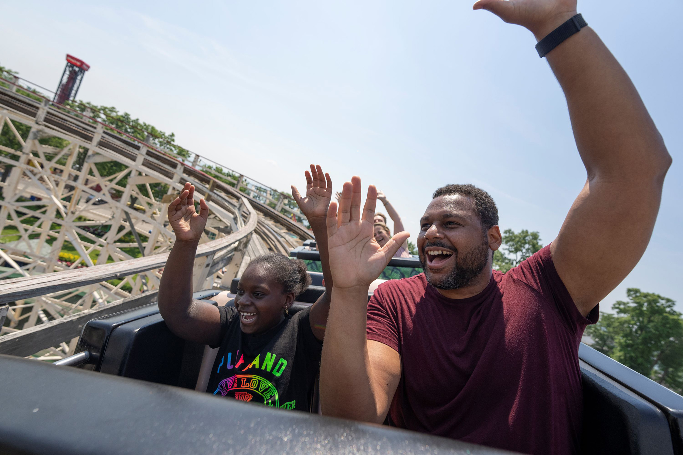 Parent and child riding Dragon Coaster front row