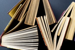 Micro of books and copy space on grey background.