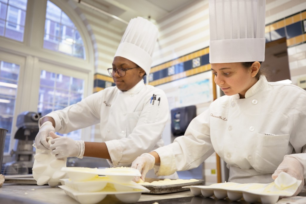 Two chefs training at the Culinary Institute of America.