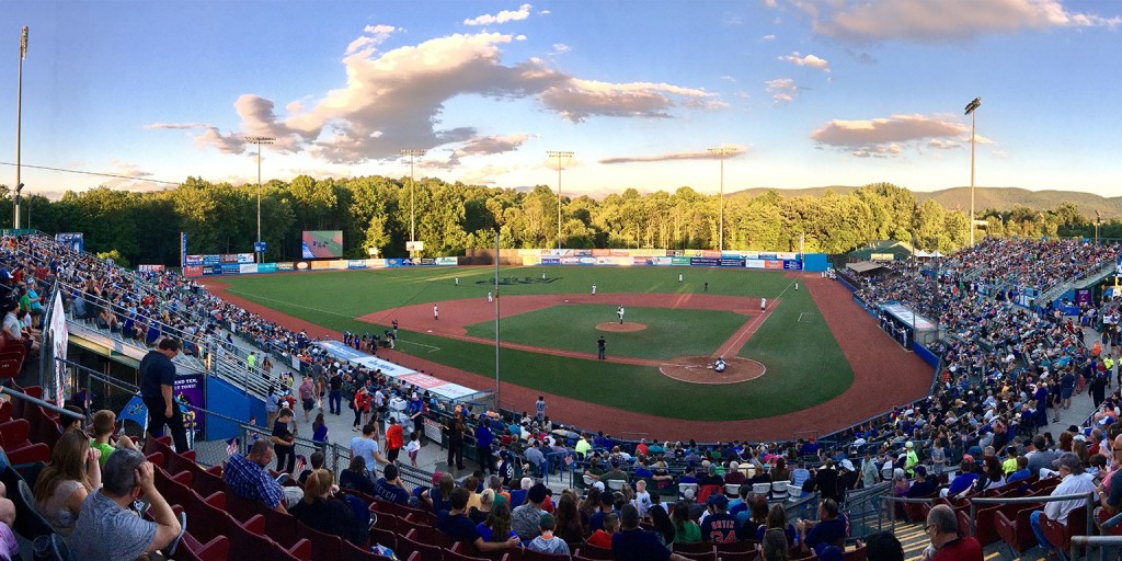 A wide-angle photo of a crowd enjoying a Hudson Valley Renegades baseball game under a beautiful blue sky at Heritage Financial Park, formerly Dutchess Stadium, Wappingers Falls