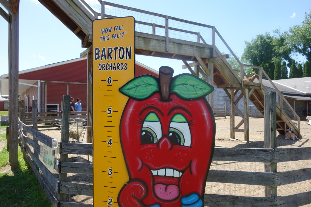 Barton Orchards sign with a cartoonish smiling apple.