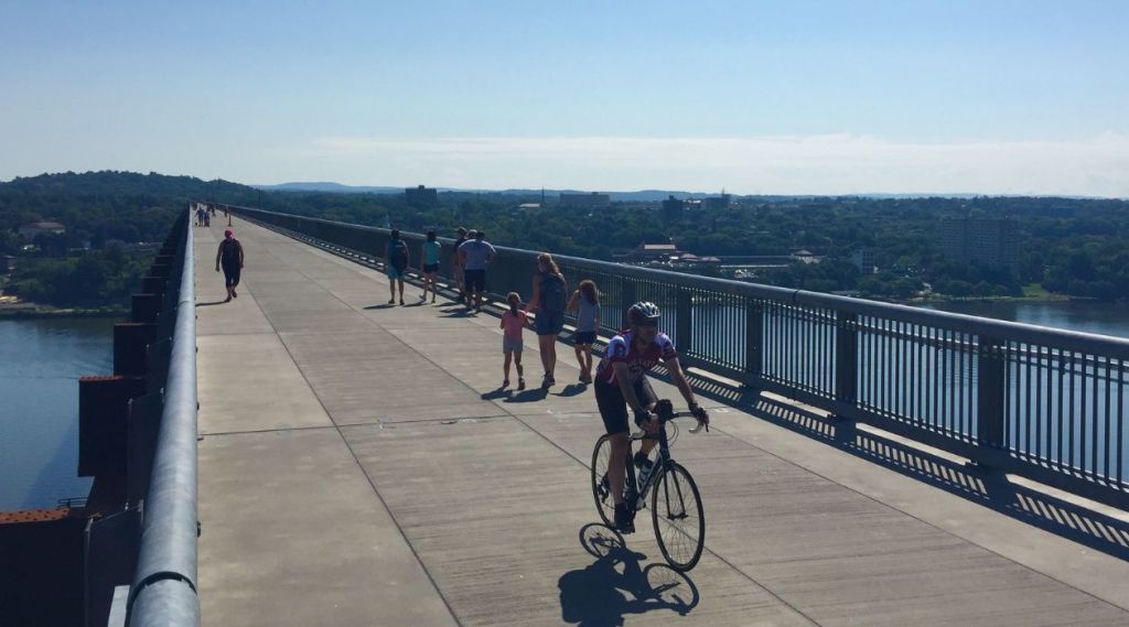 A cyclist pedals across the Walkway Over the Hudson.