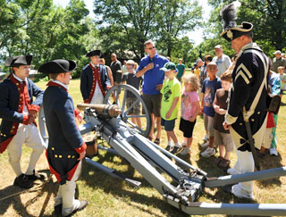 Historical reenactors and tour group at New Windsor Cantonment State Historic Site