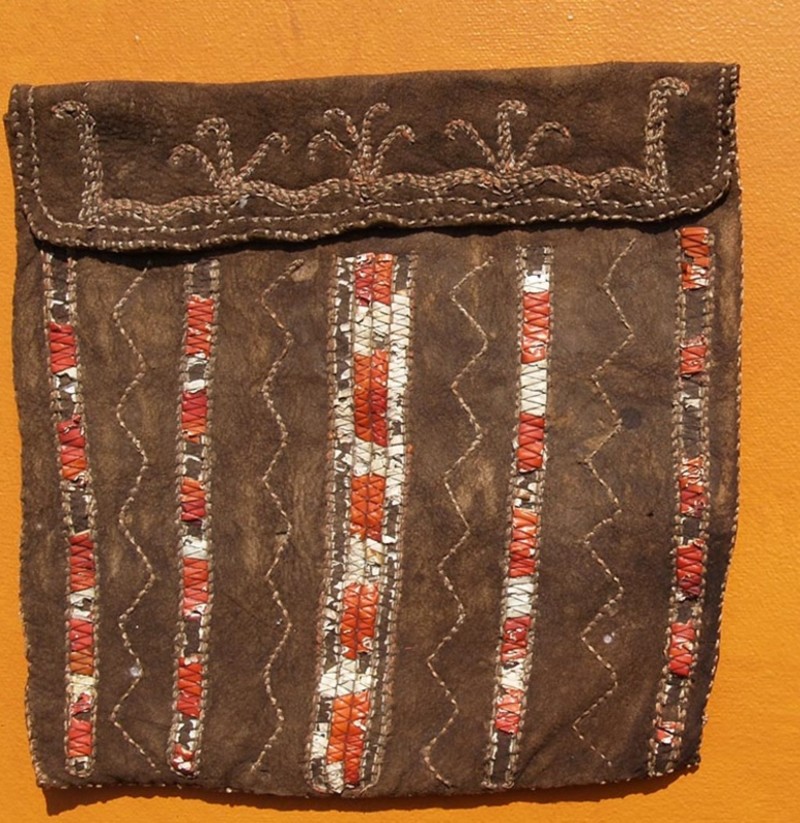 A handcrafted brown pouch with ornate orange and white trim similar to the ones likely used by members of the Indigenous tribes who first inhabited the Hudson Valley.