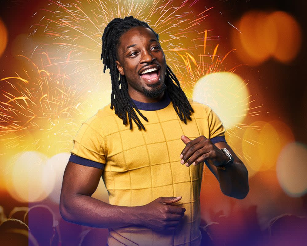 Comedian Preacher Lawson with sparks and bright lights in the background.