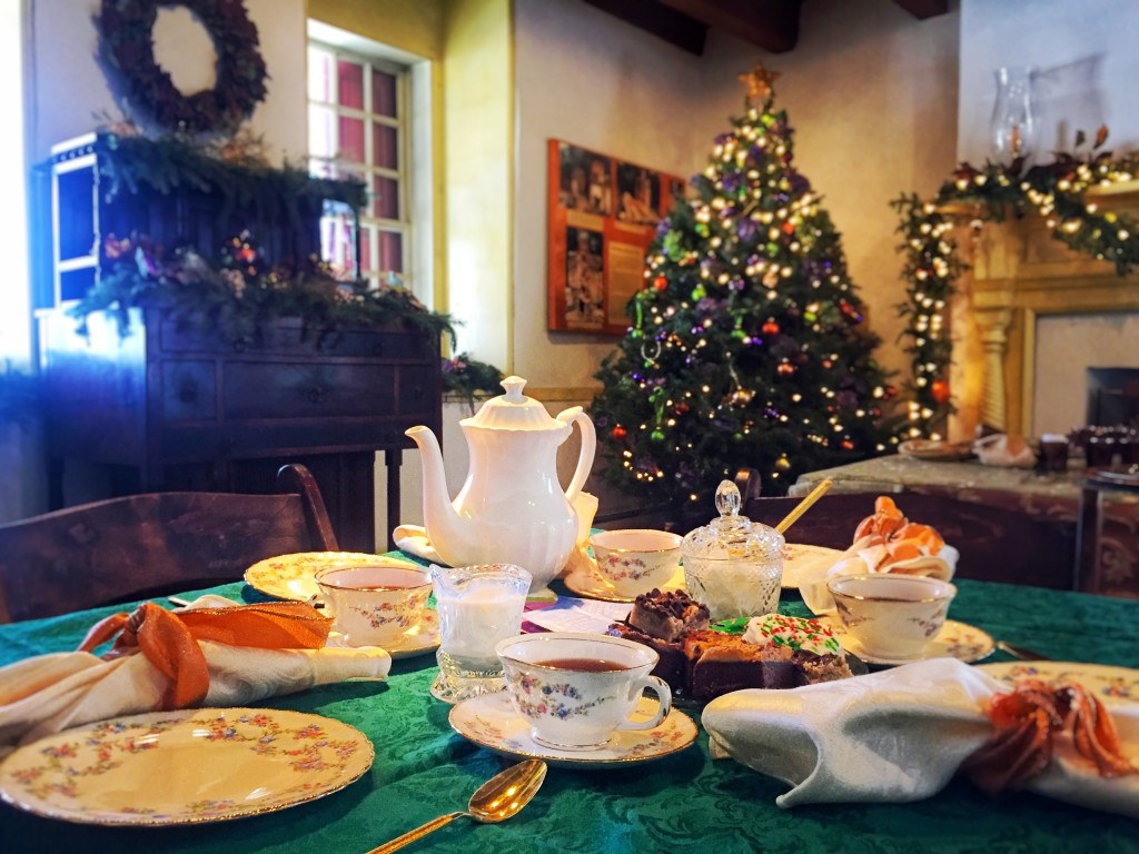 A table festively decorated and set for a social tea in front of a decorated Christmas tree at Mount Gulian Historic Site in Beacon.