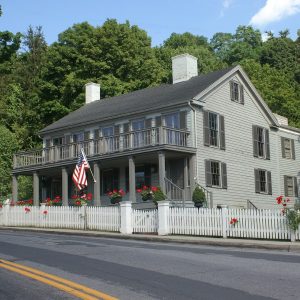 The outside of the Horace Greeley House adorned with garland.