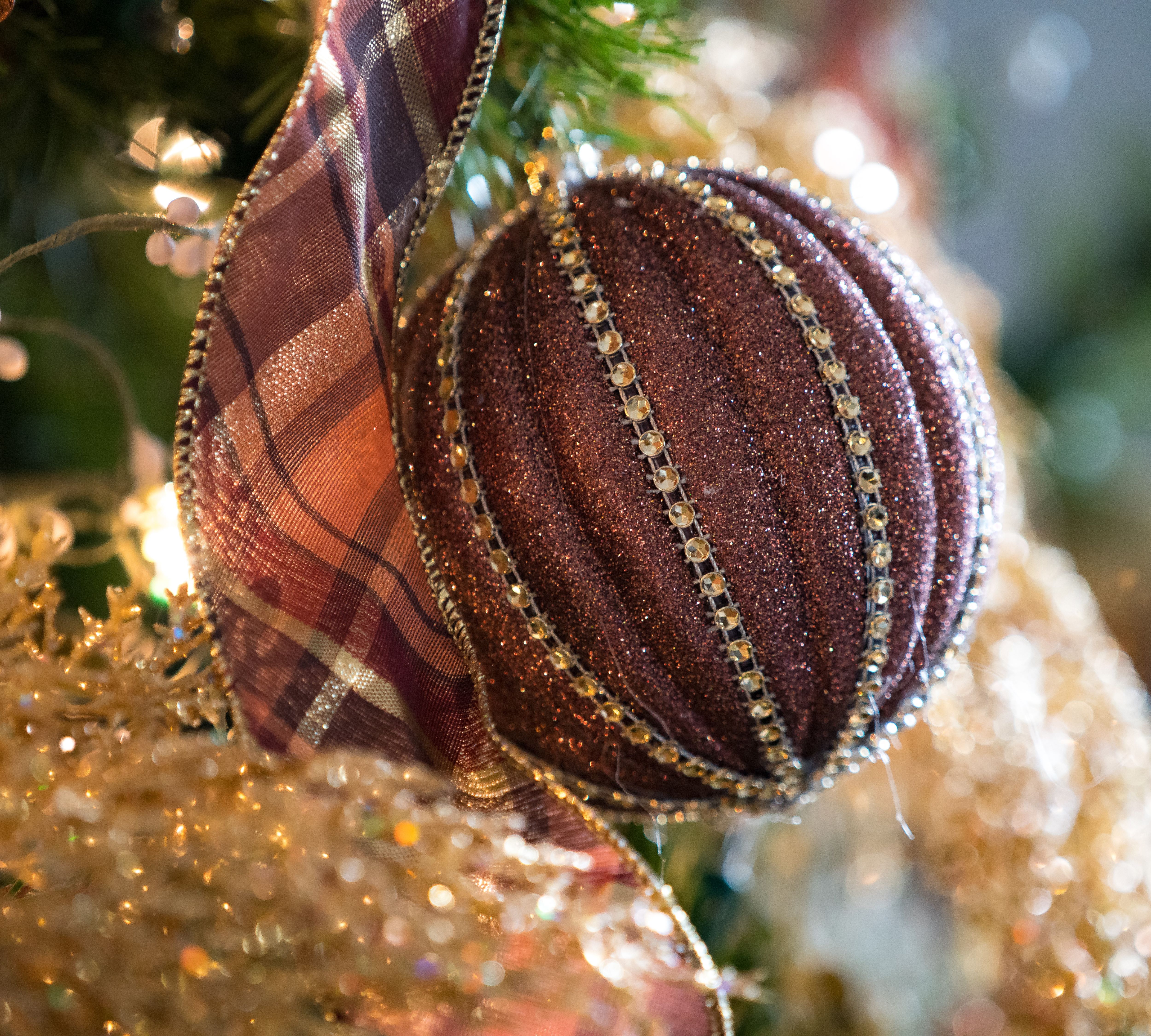 A round, red ornament adorns a tree inside Lyndhurst Mansion.