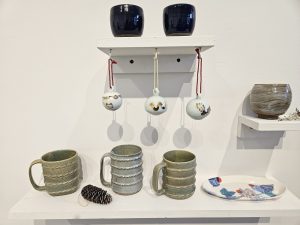 Ornaments and mugs are on display at Clay Art Center.