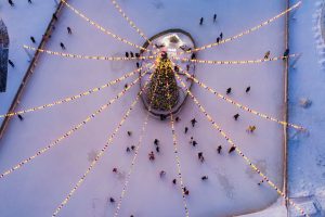 A view of an ice skating rink and holiday tree from above.