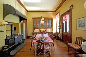 The kitchen of the Octagon House with stove and table in the center.