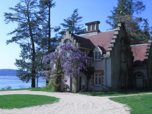 The exterior of Washington Irving's Sunnyside home with purple wisteria climbing the structure.