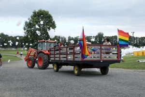 A farm tractor and trailer decorated with Pride flags at Barton Orchards in Poughquag