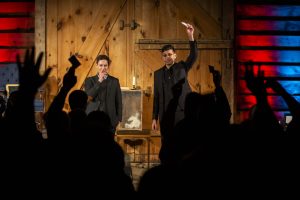 Two illusionists perform on stage.