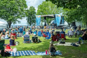 An audience gathers on the lawn to listen to music at the festival.