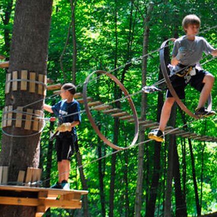 Kids on an outdoor climbing gym at Catamount Mountain Resort