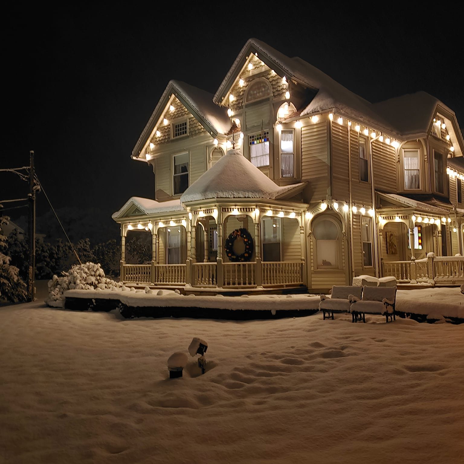 Exterior of Albergo Hotel at night in snow