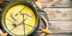 Bread pieces on sticks dipped in a cheese fondue