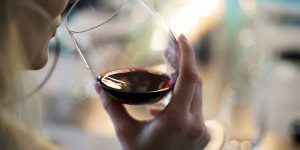 Woman tasting red wine