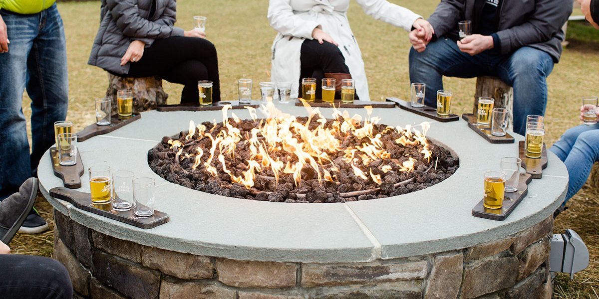 People gathered around an Angry Orchard campfire in Walden.